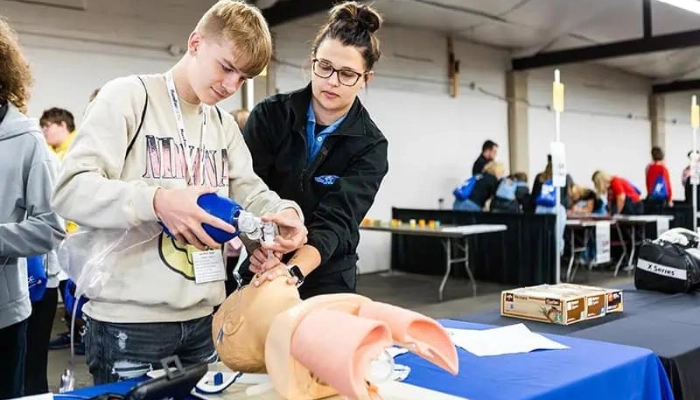 Student at MakerFest learns how a bag valve mask works